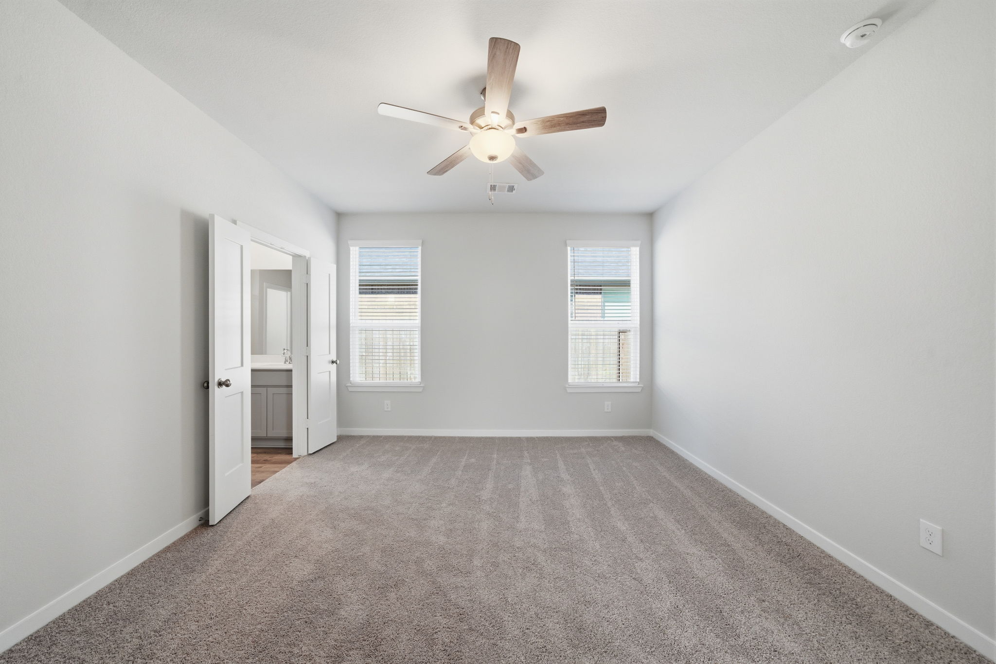 A room with a ceiling fan and a ceiling fan.