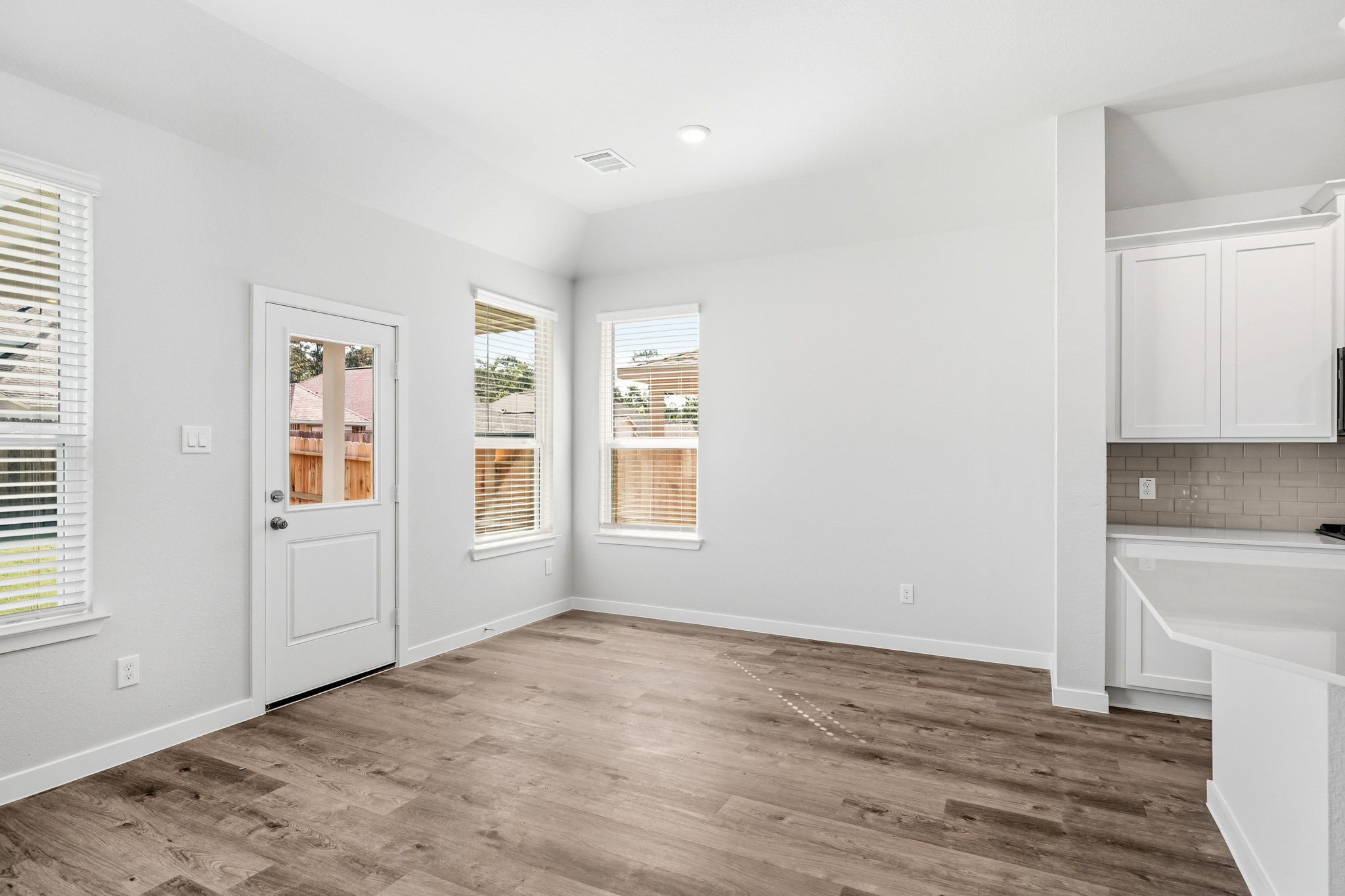 A kitchen with white cabinets.