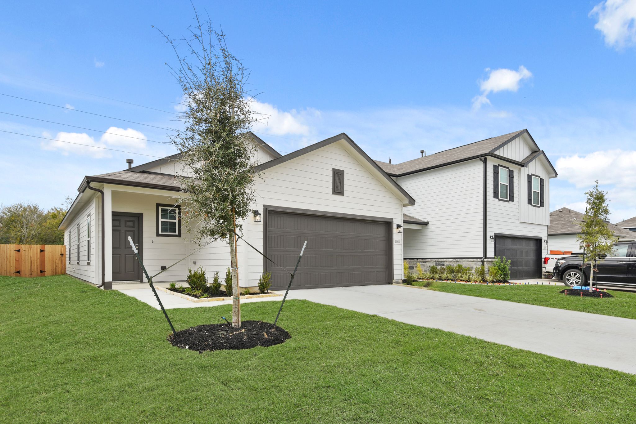 A house with a tree in the front yard.