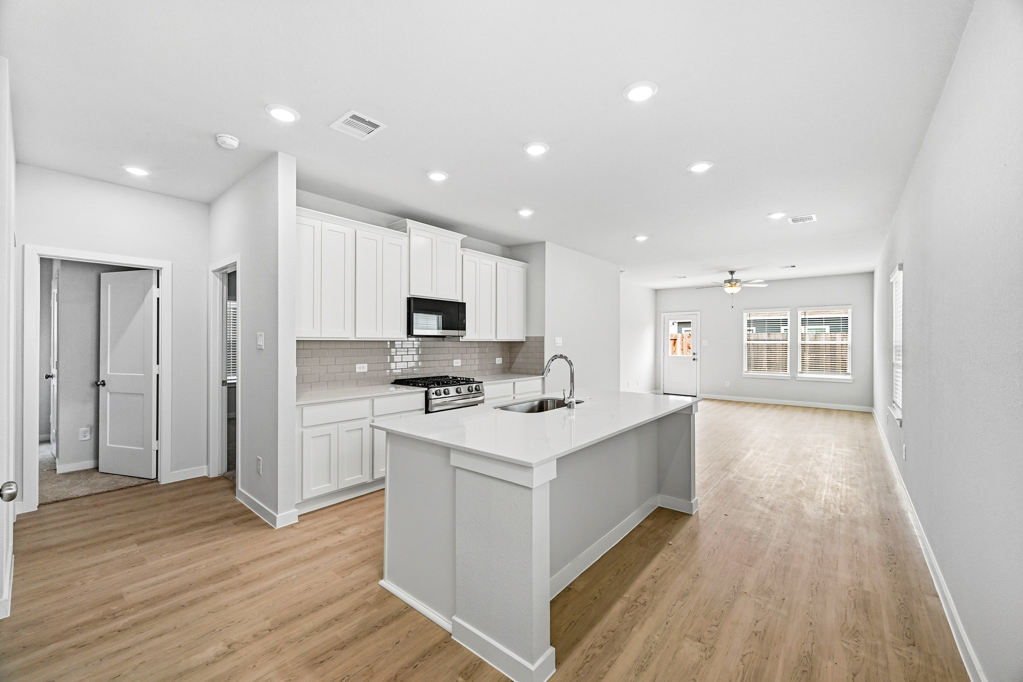 A kitchen with white cabinets.
