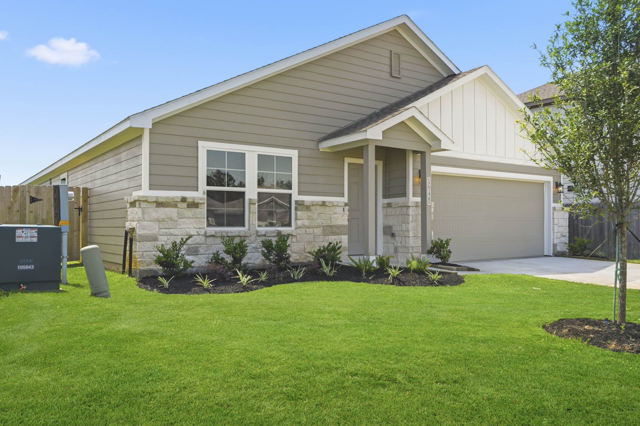 A house with a lawn with Southfork Ranch in the background.