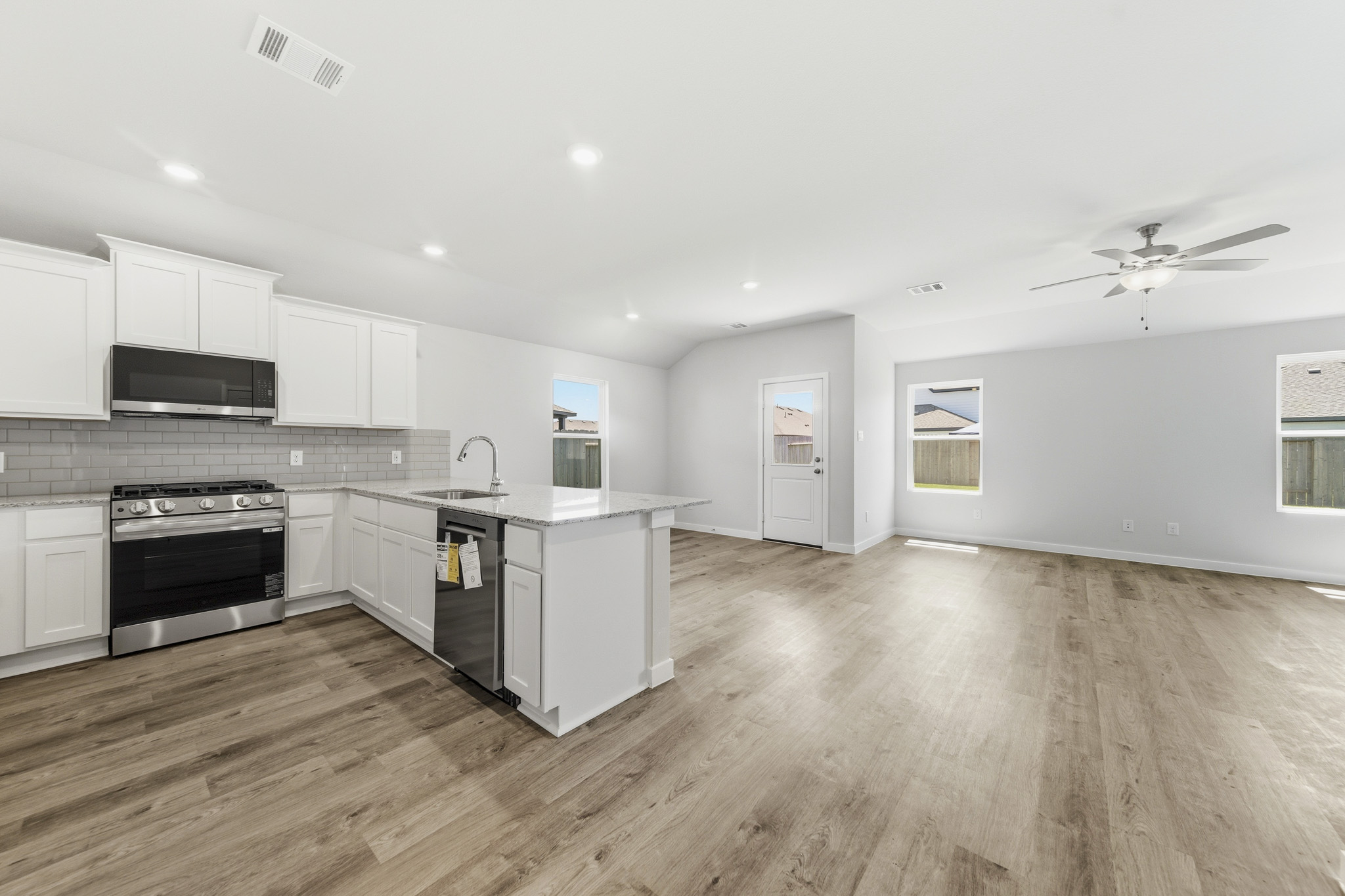 A kitchen with white cabinets.
