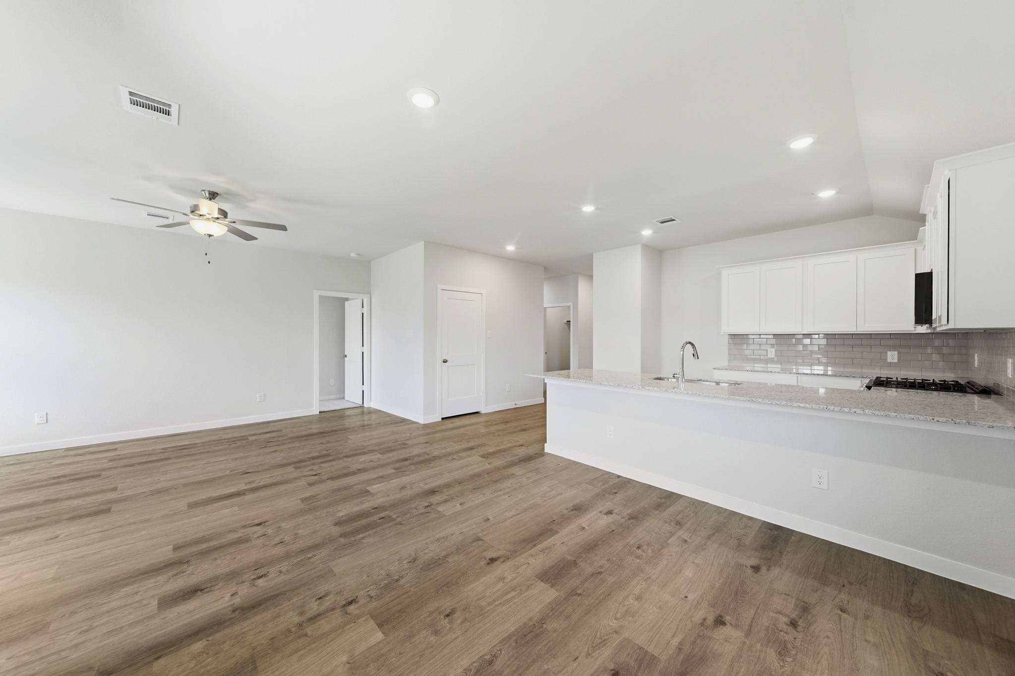 A large kitchen with white cabinets.
