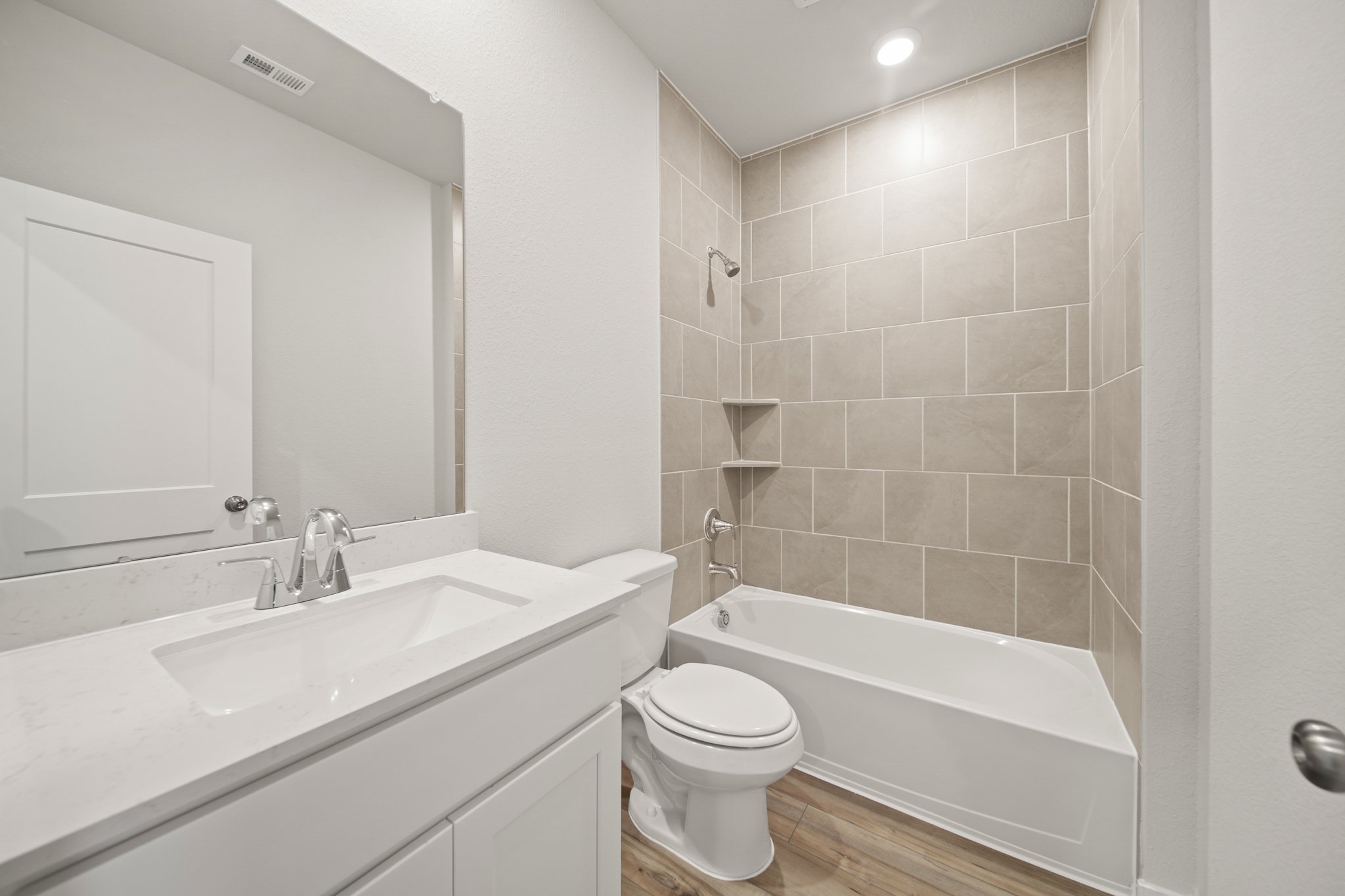 A bathroom with a tub sink and toilet.