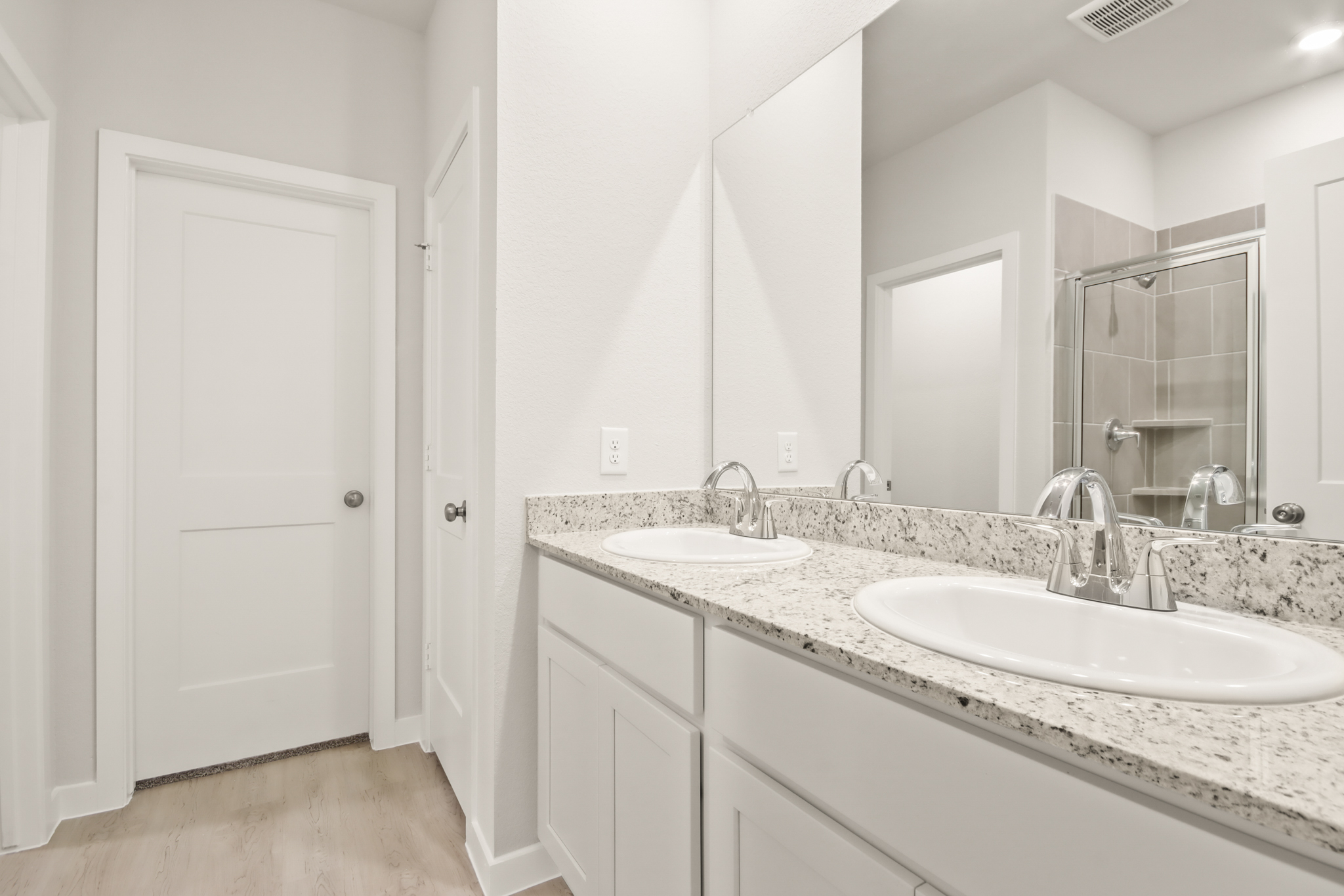 A bathroom with a large mirror.