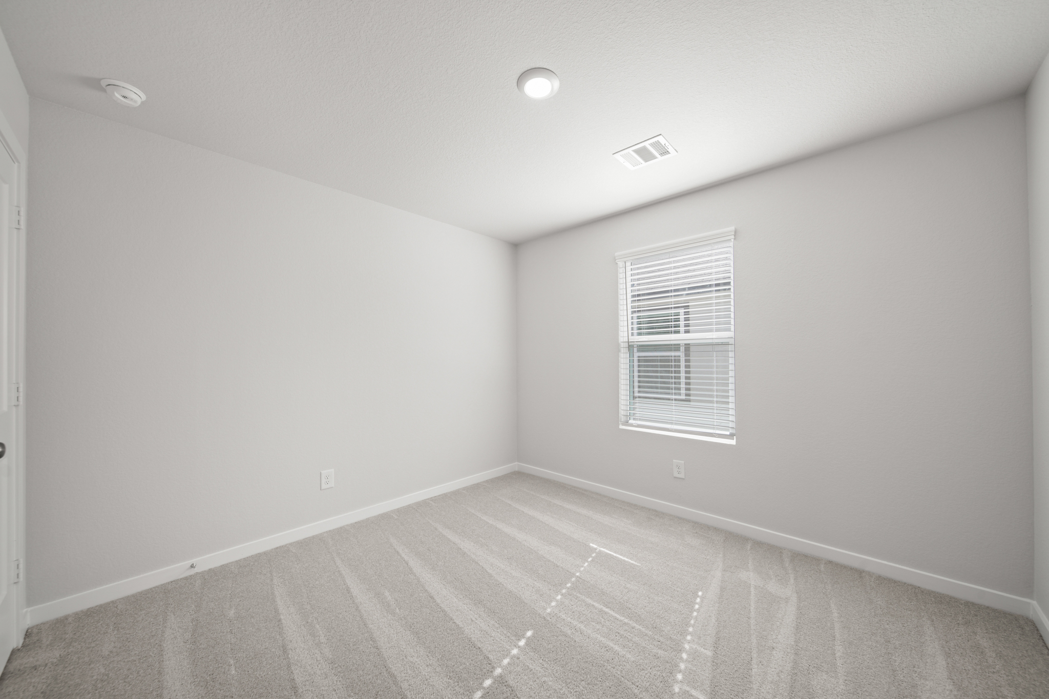 A room with a tile floor and a window.