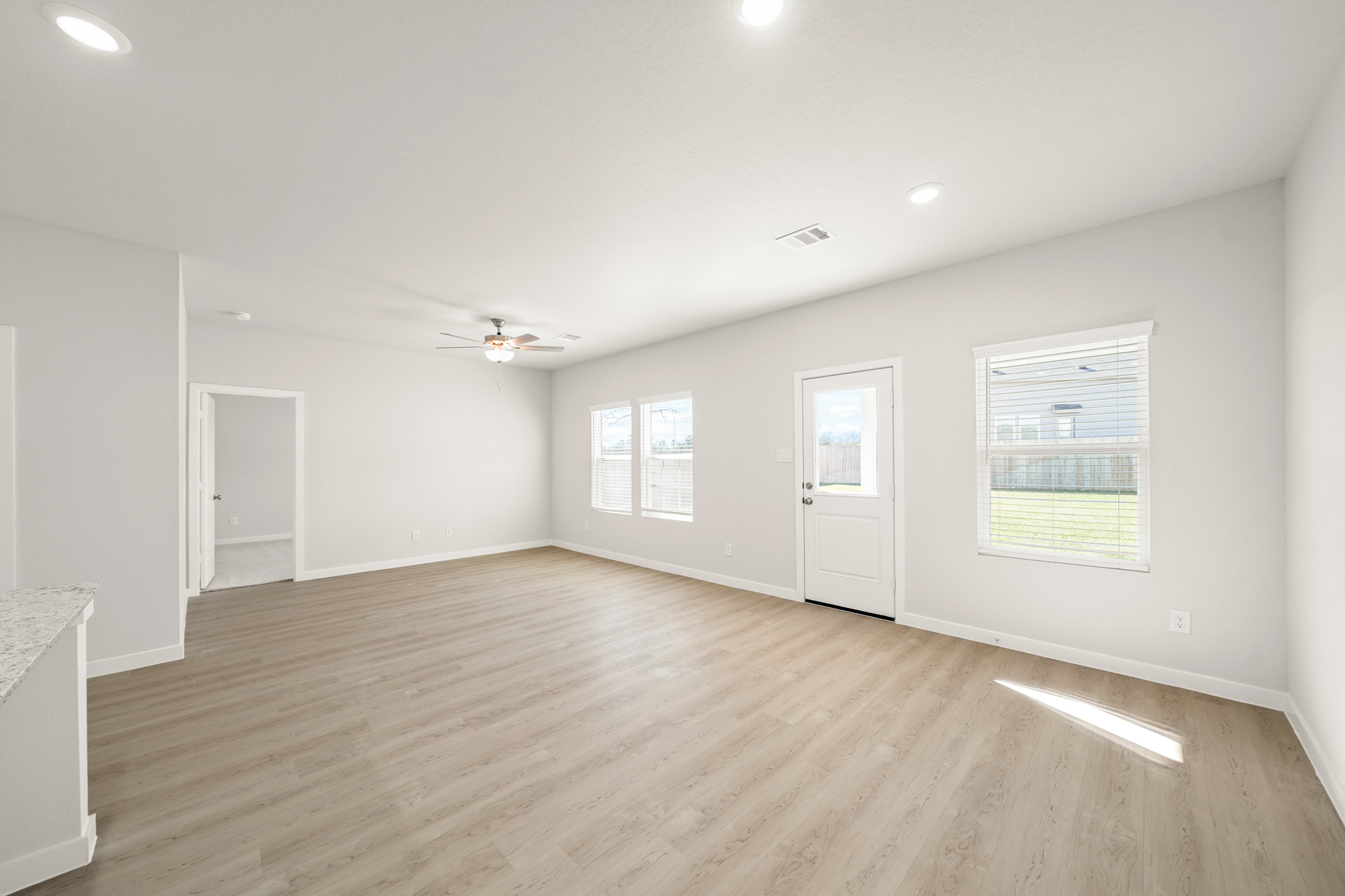 A room with a wood floor and white walls.