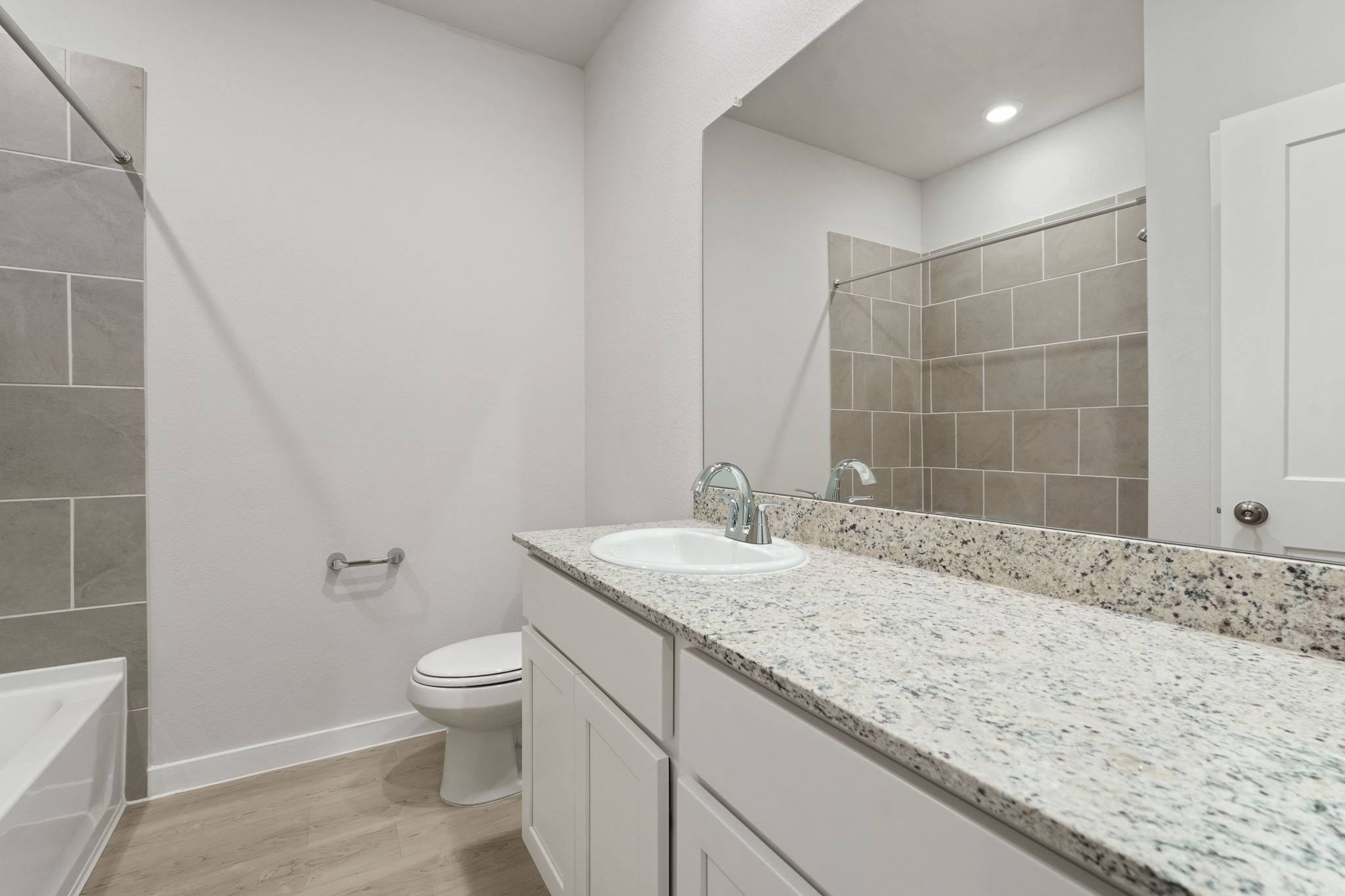 A bathroom with a marble countertop.