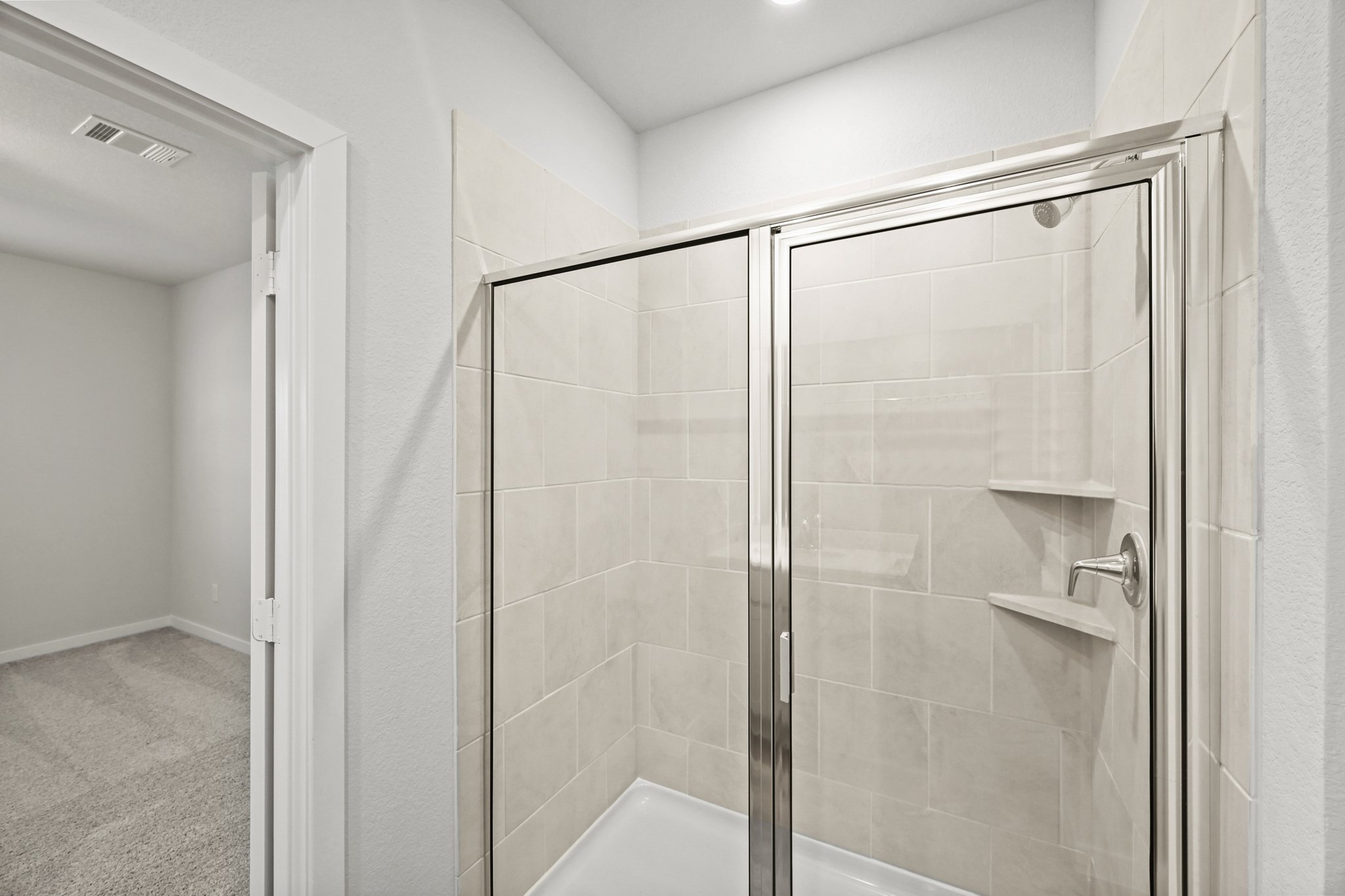 A shower with a glass door.