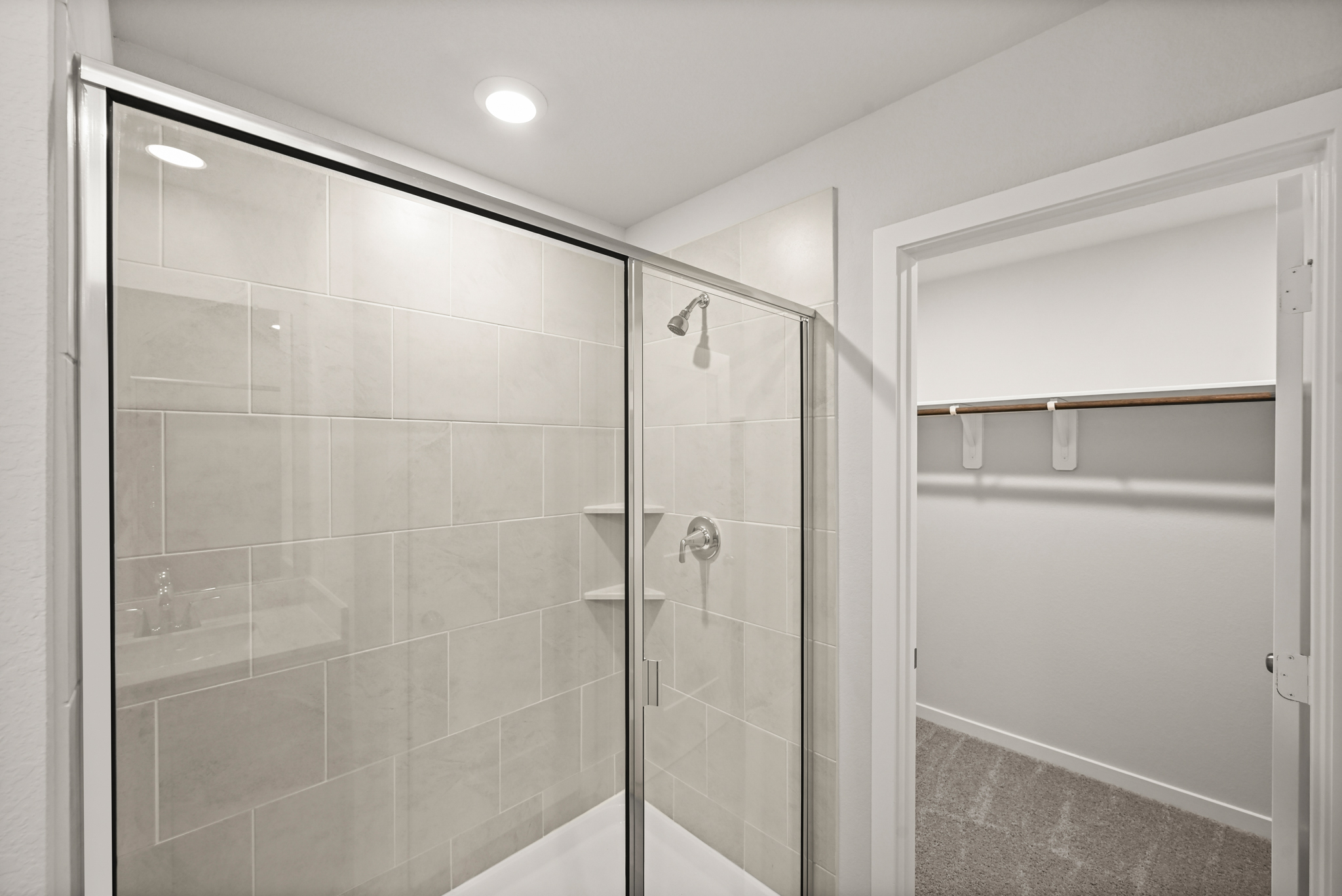 A shower with a glass door.