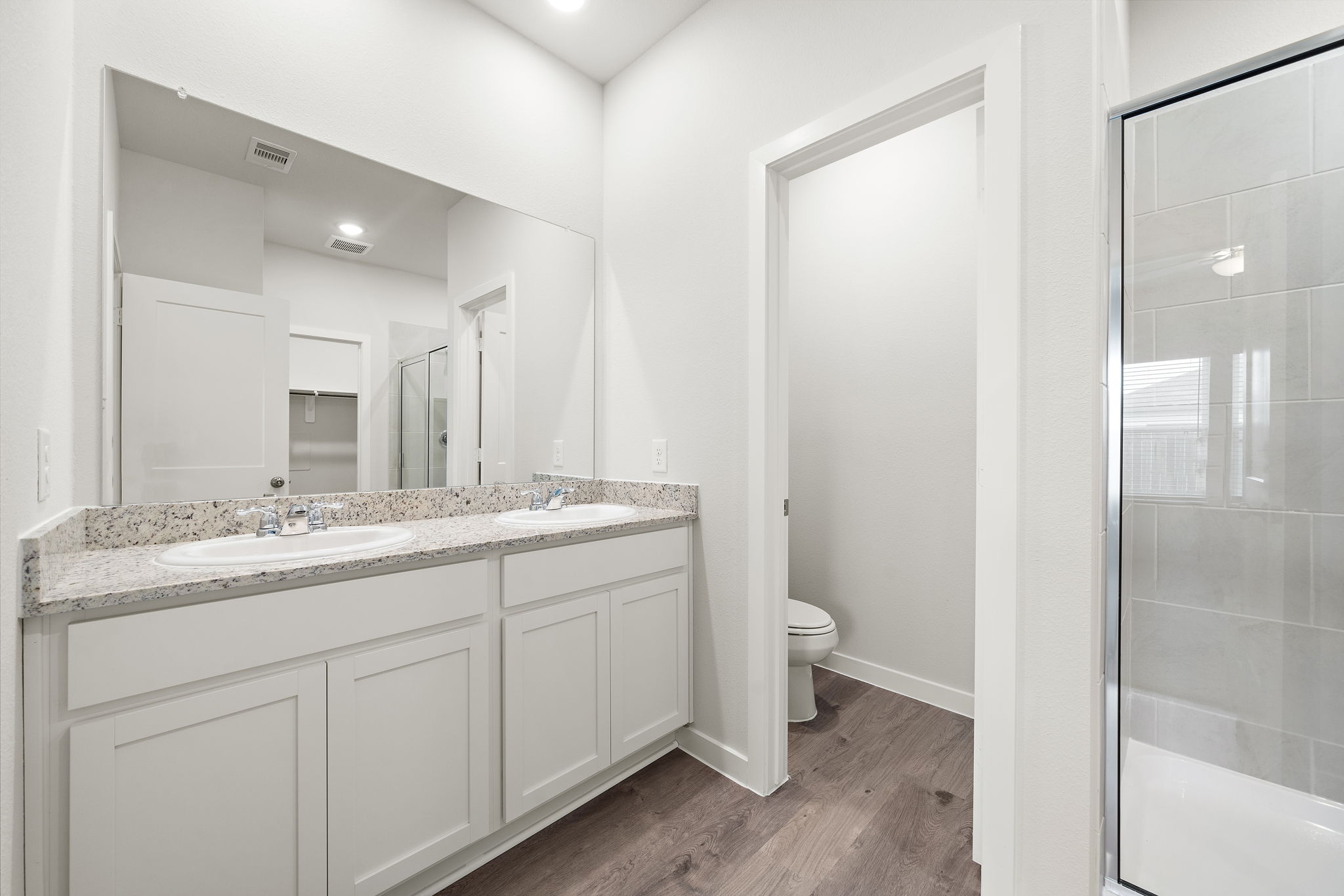A bathroom with a glass shower.