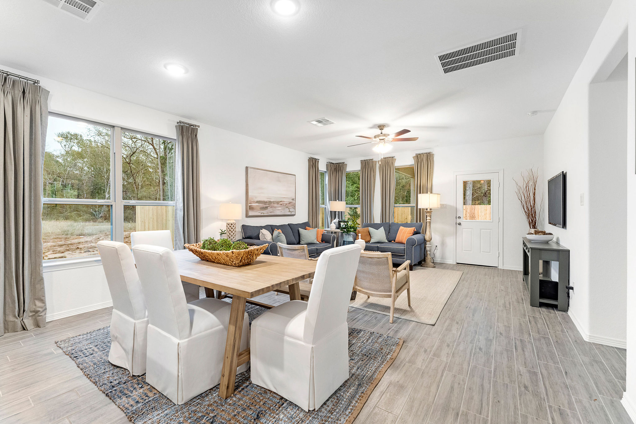 A living room with a dining table and chairs.