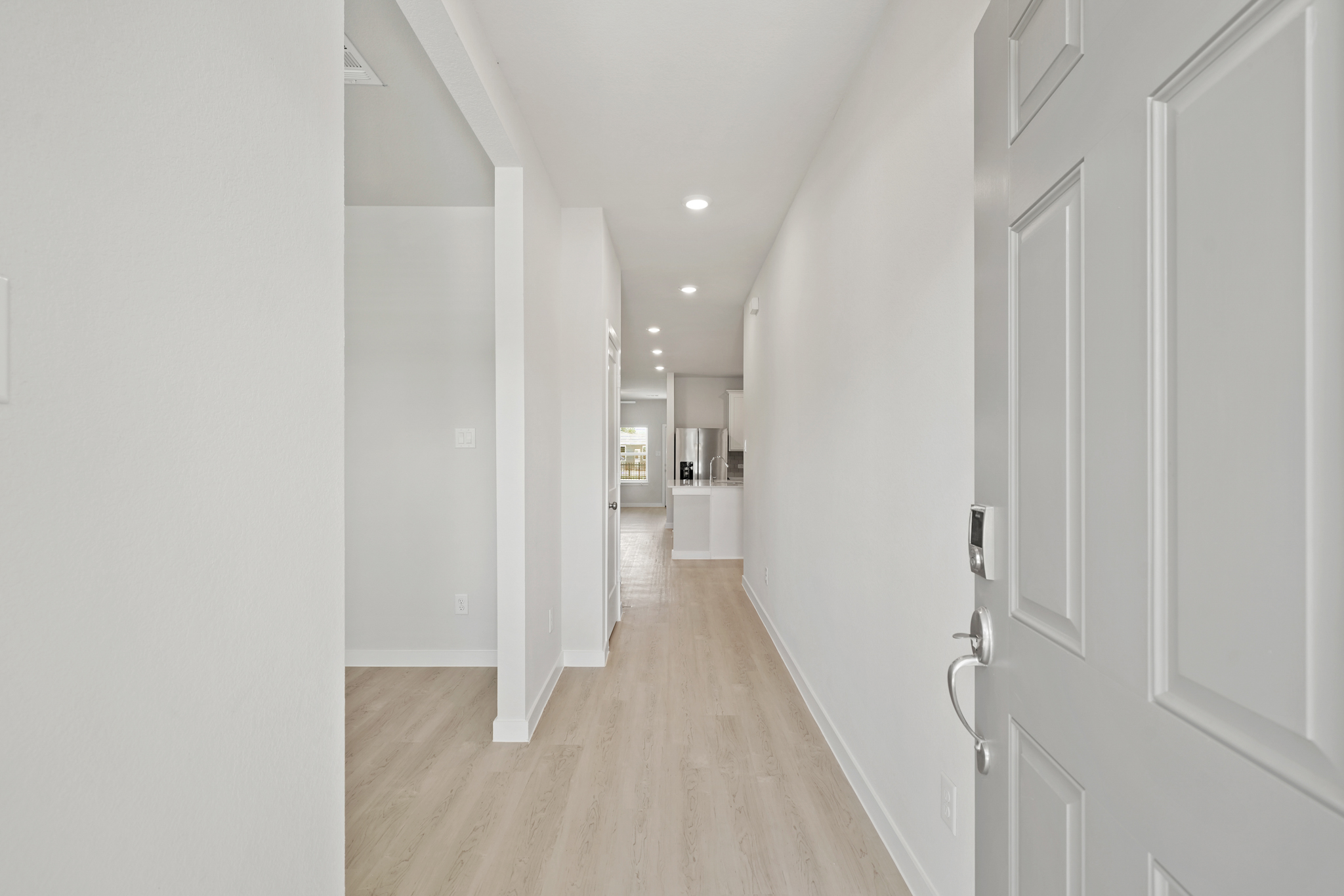 A hallway with white doors.