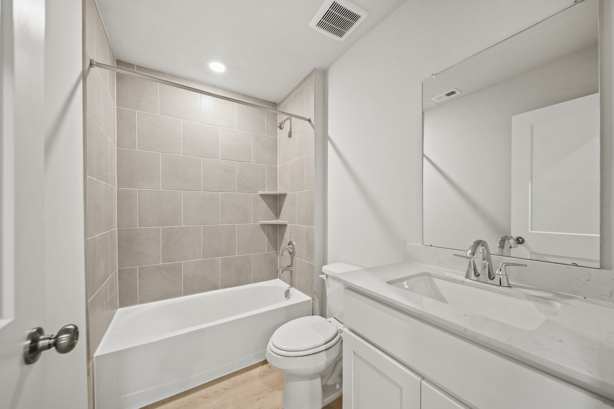 A bathroom with a tub sink and toilet.