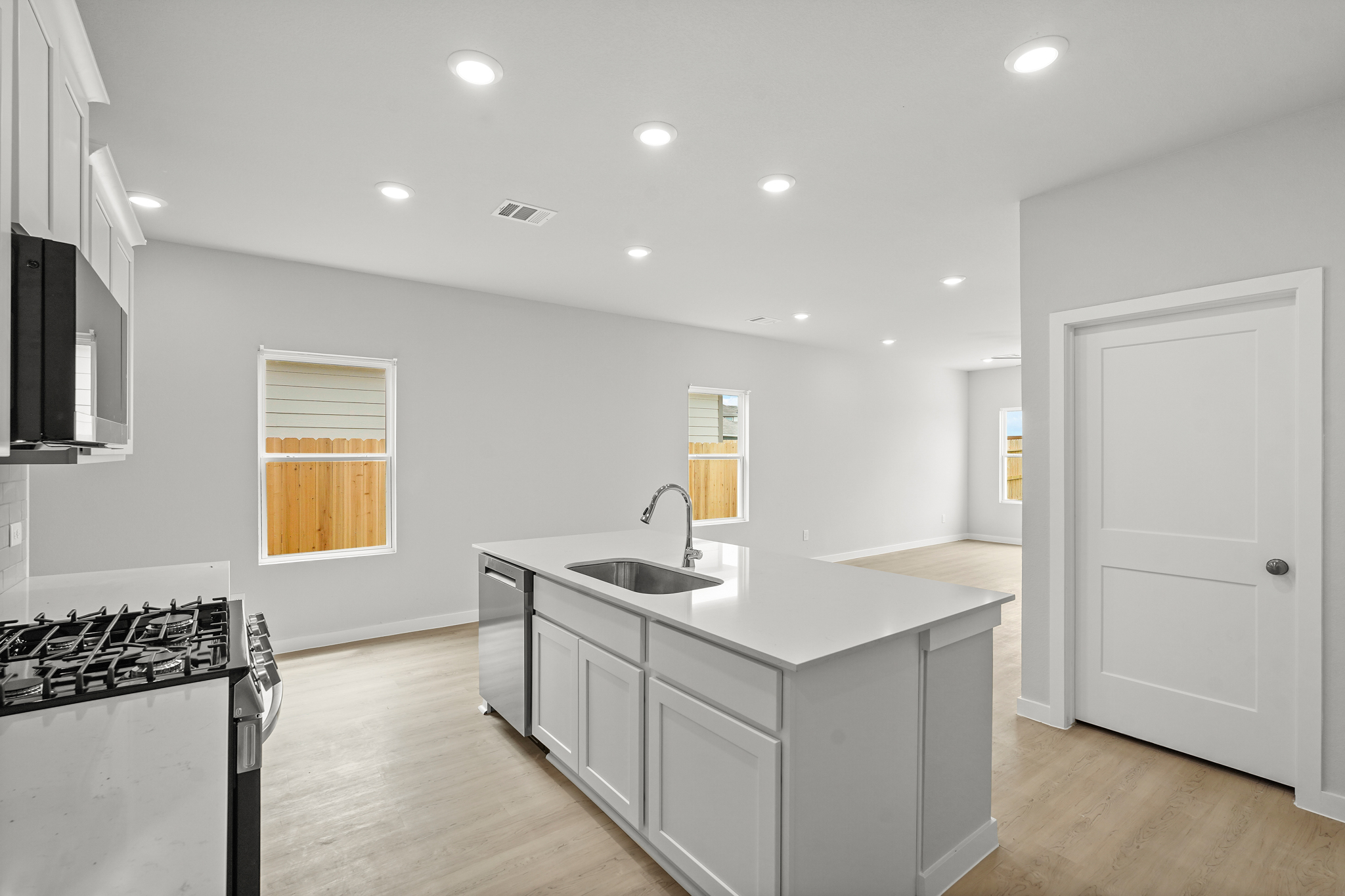 A kitchen with white cabinets.