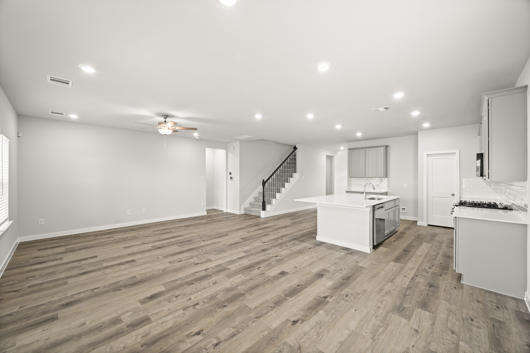 A large kitchen with a wood floor.