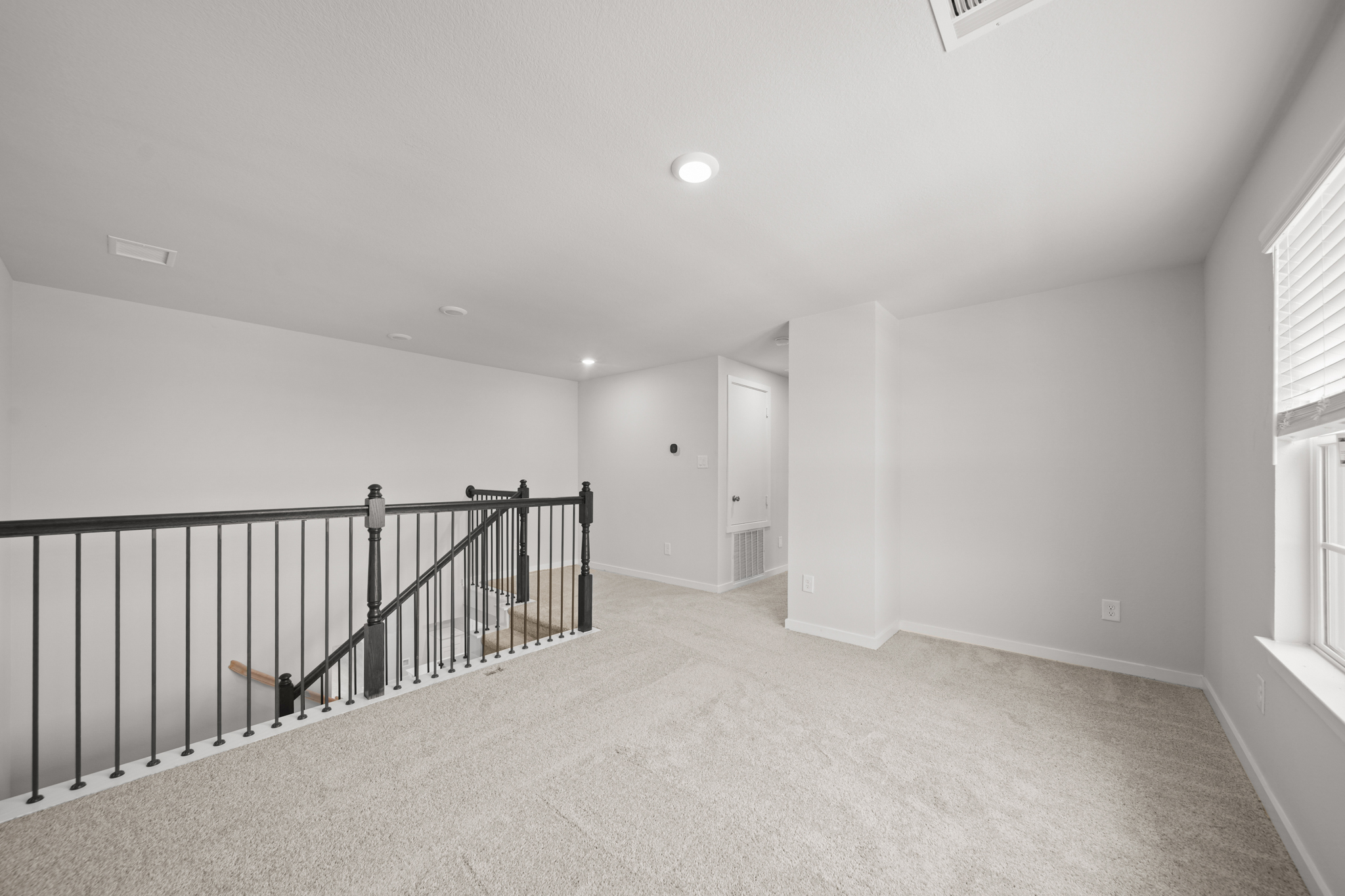 A hallway with a railing.