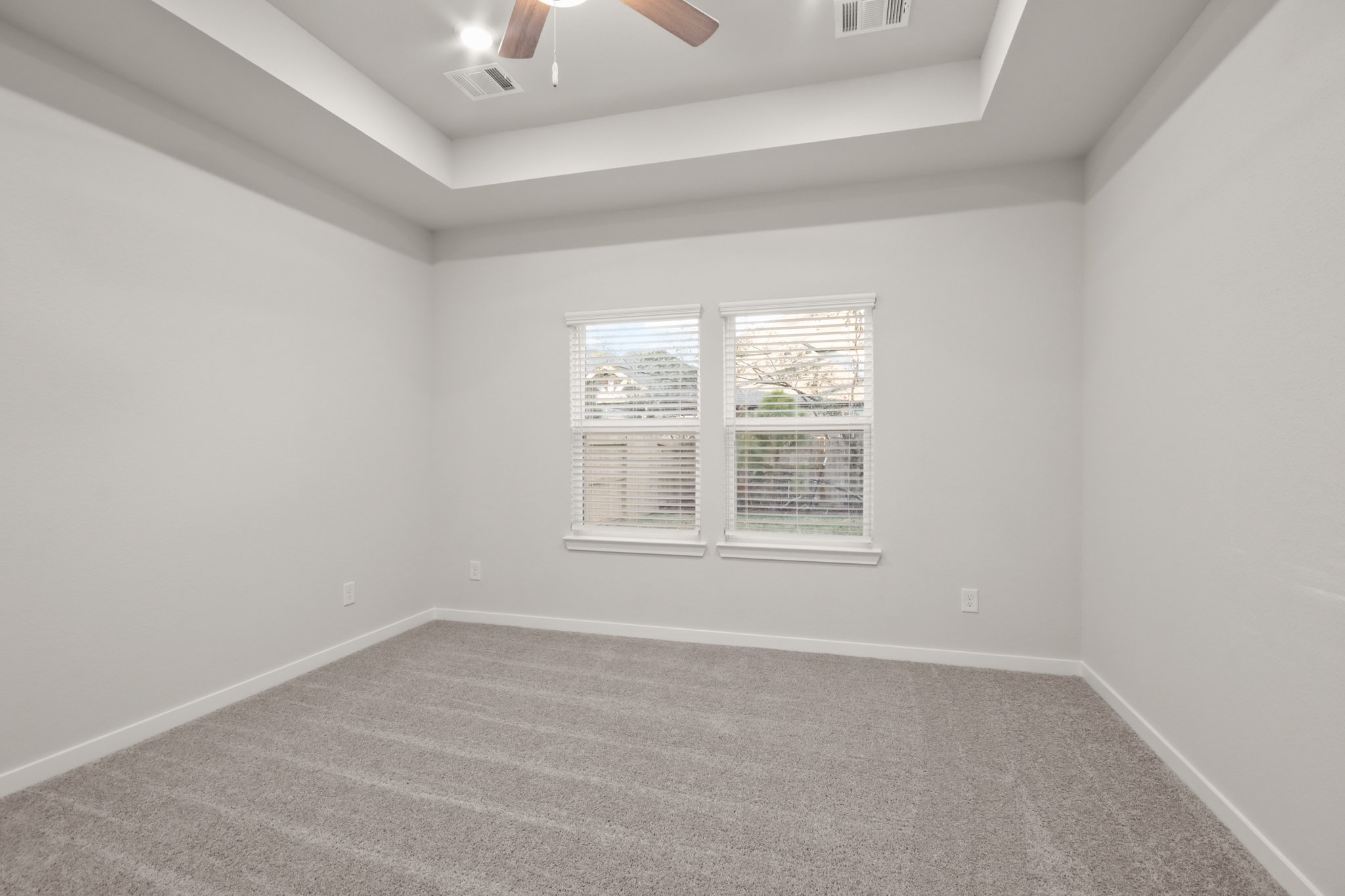 A room with a window and a carpet.