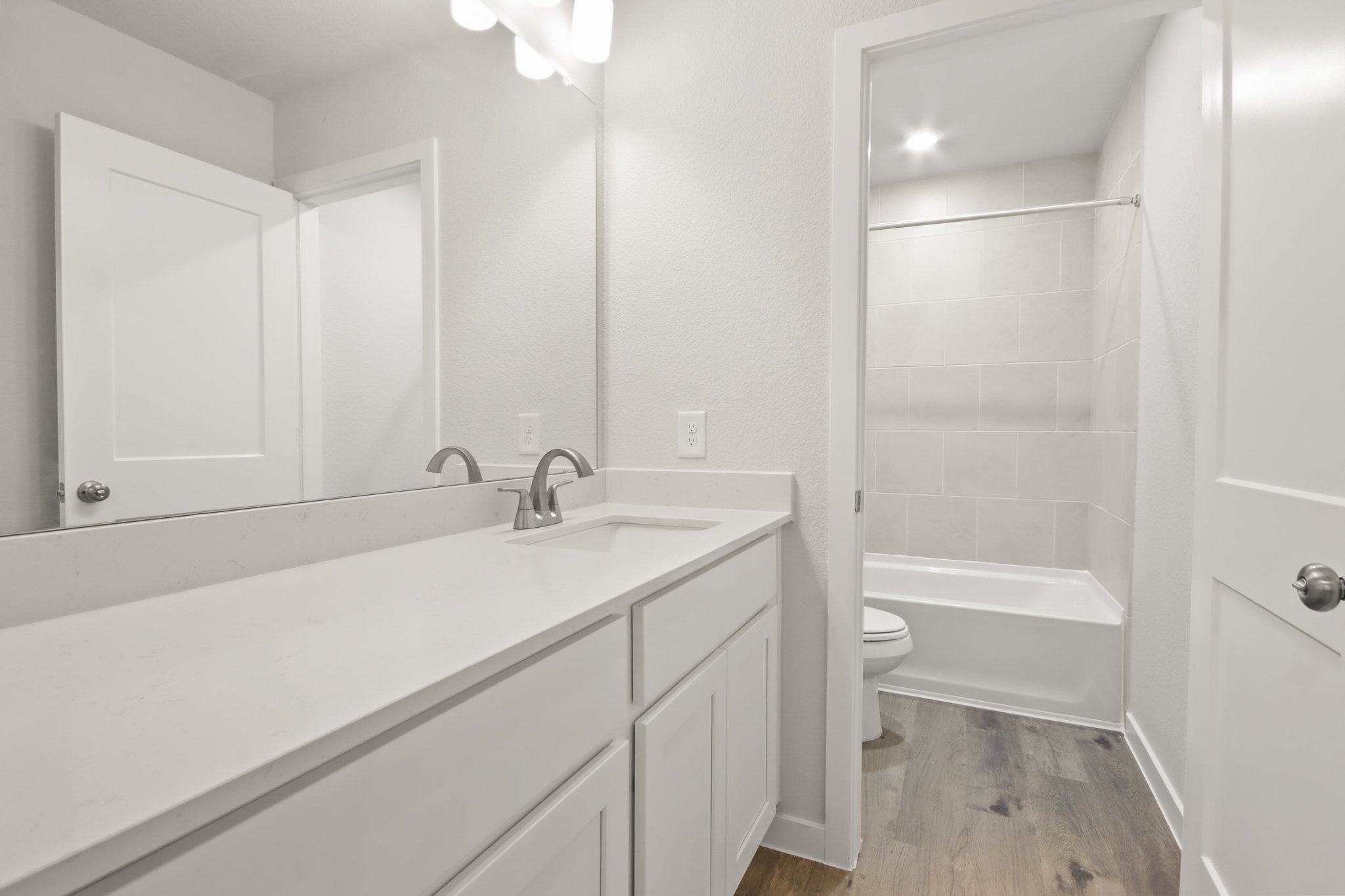 A bathroom with a tub sink and toilet.