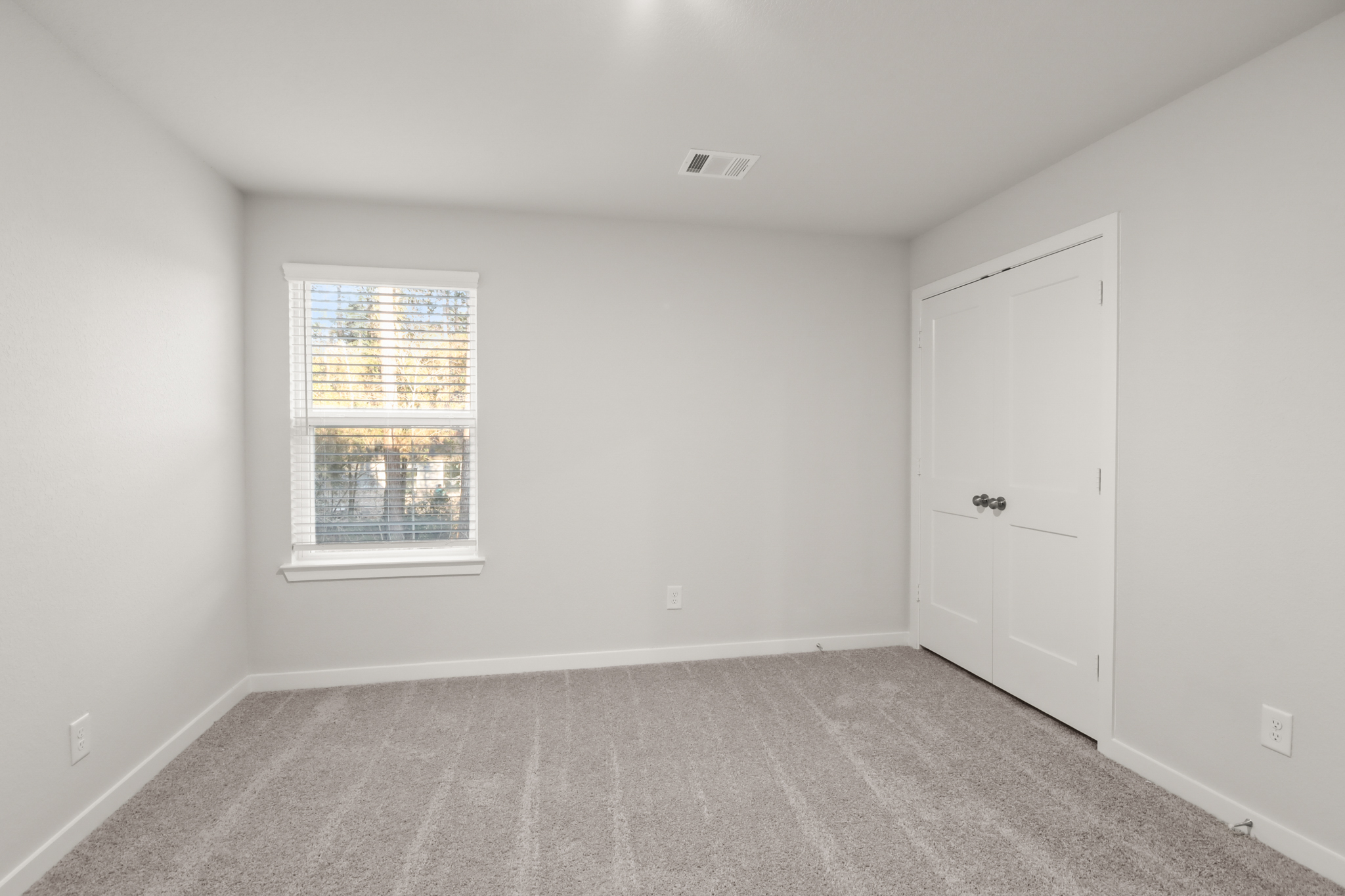 A room with a window and a door.