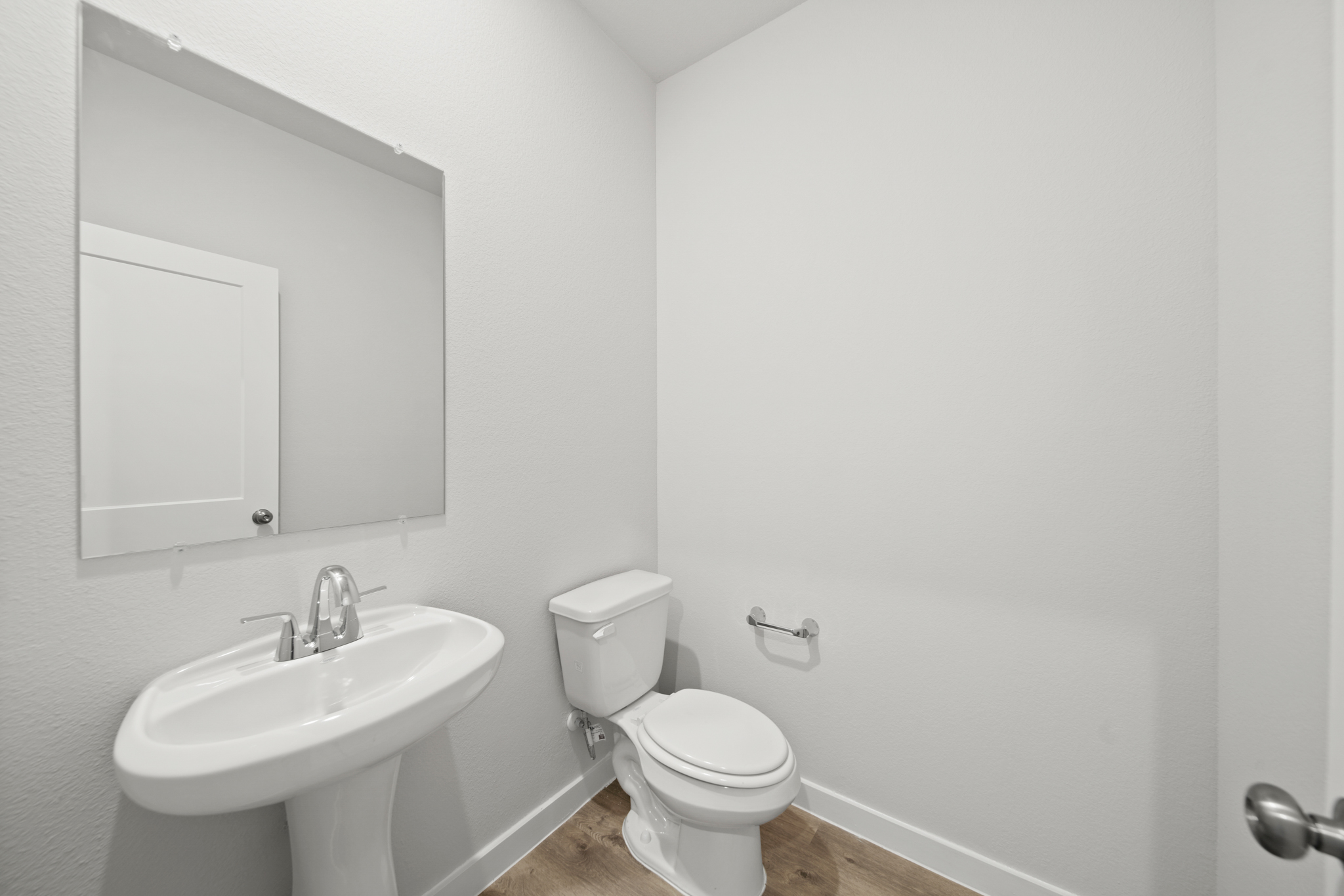 A bathroom with a toilet and sink.