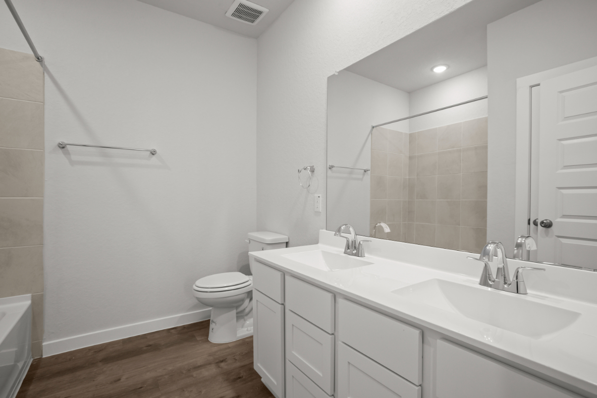 A bathroom with a large mirror.