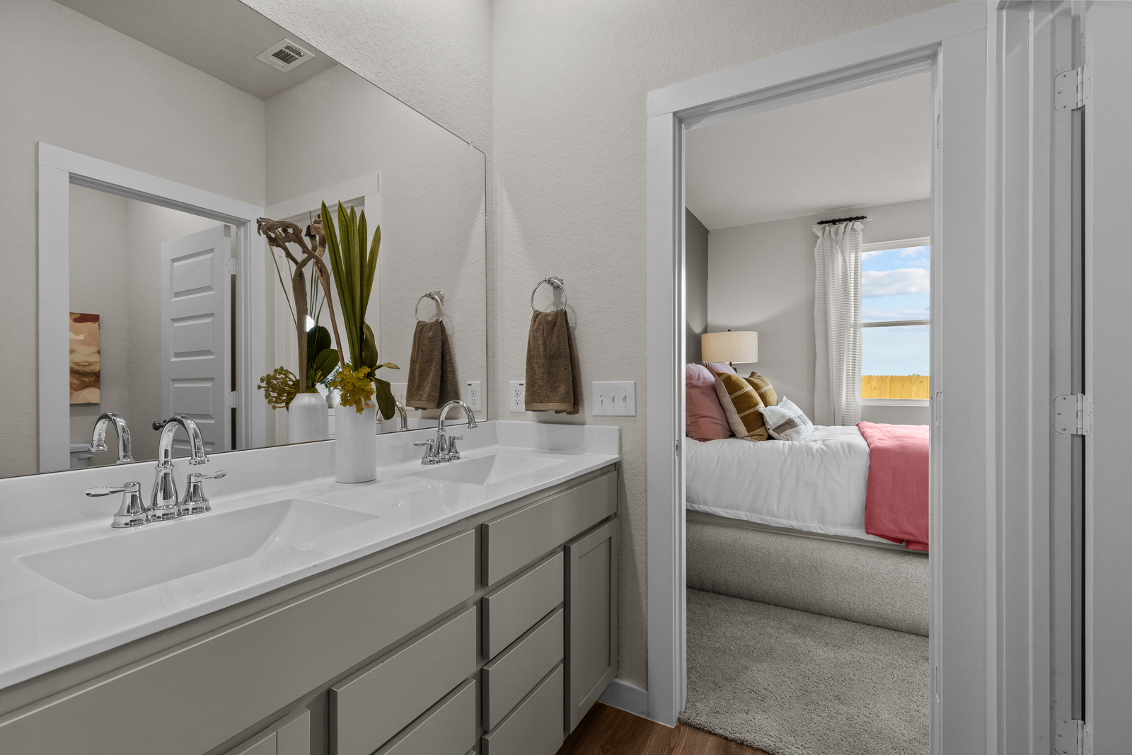 A bathroom with a sink and a bed.