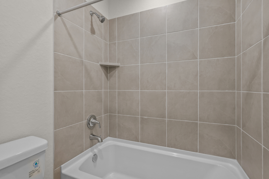A bathroom with a bathtub and toilet.