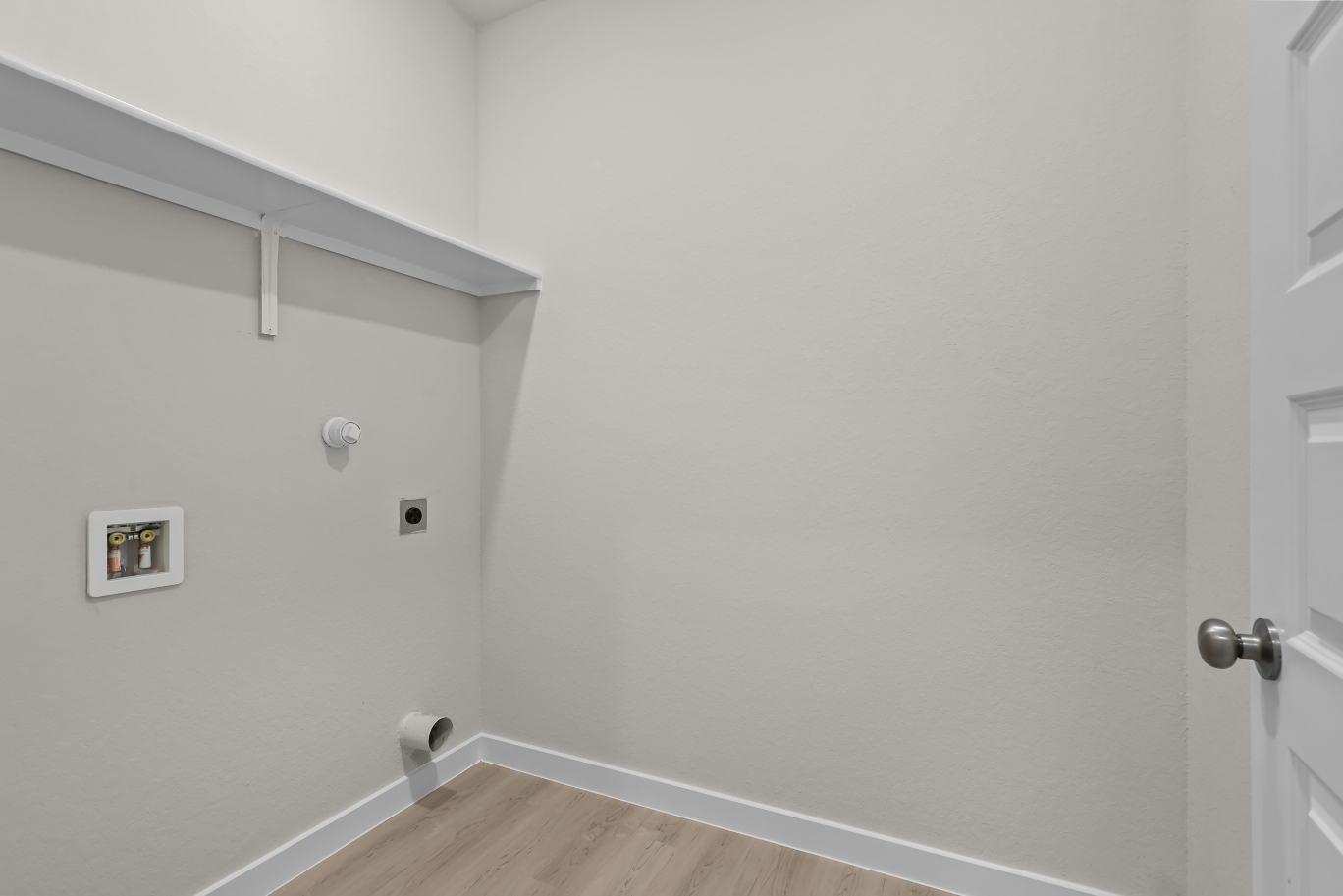 A white wall with a light switch.
