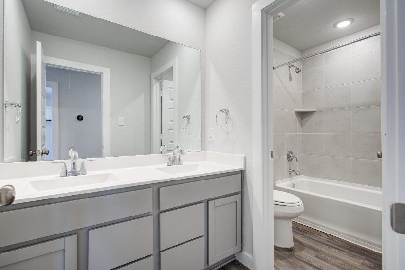 A bathroom with a tub sink and toilet.