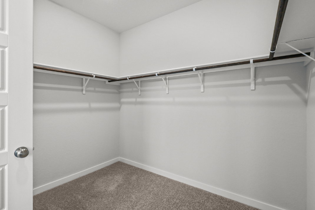 A white wall with a metal railing.