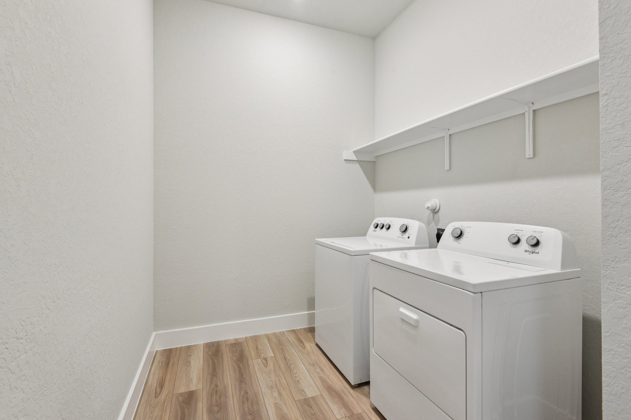 A white bathroom with a sink and a white cabinet.