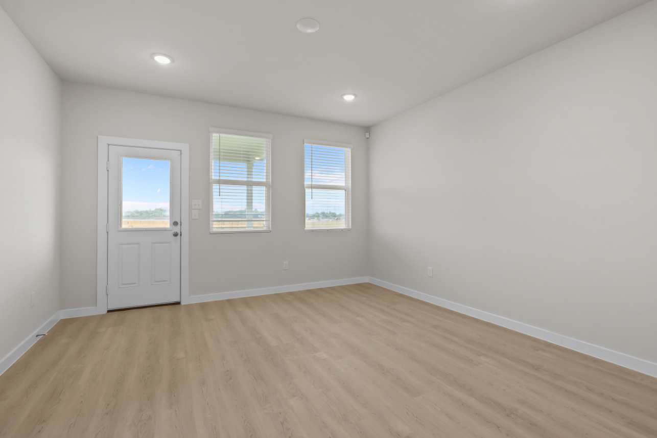 A room with a wood floor and white walls.