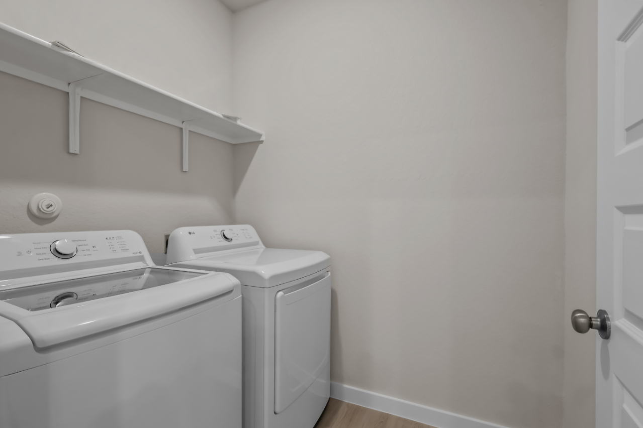 A washing machine and dryer in a room.