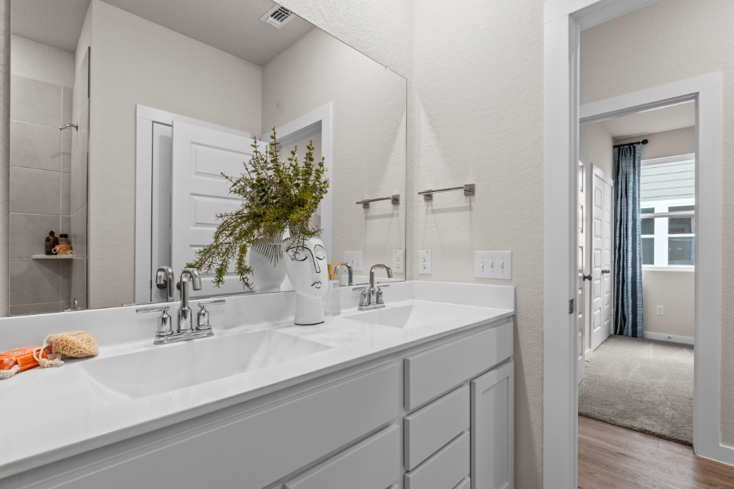 A bathroom with a large mirror.
