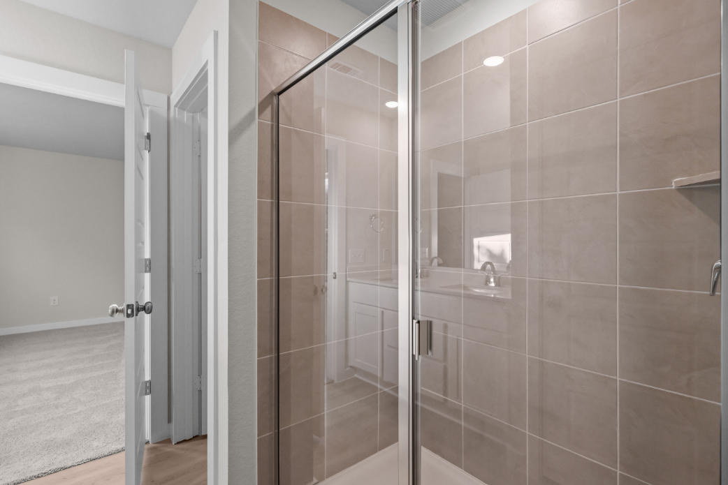 A shower with glass doors.