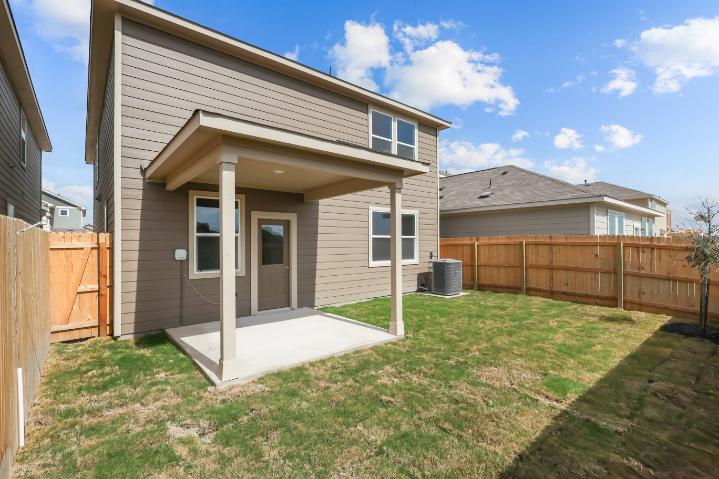 A house with a fence and grass.