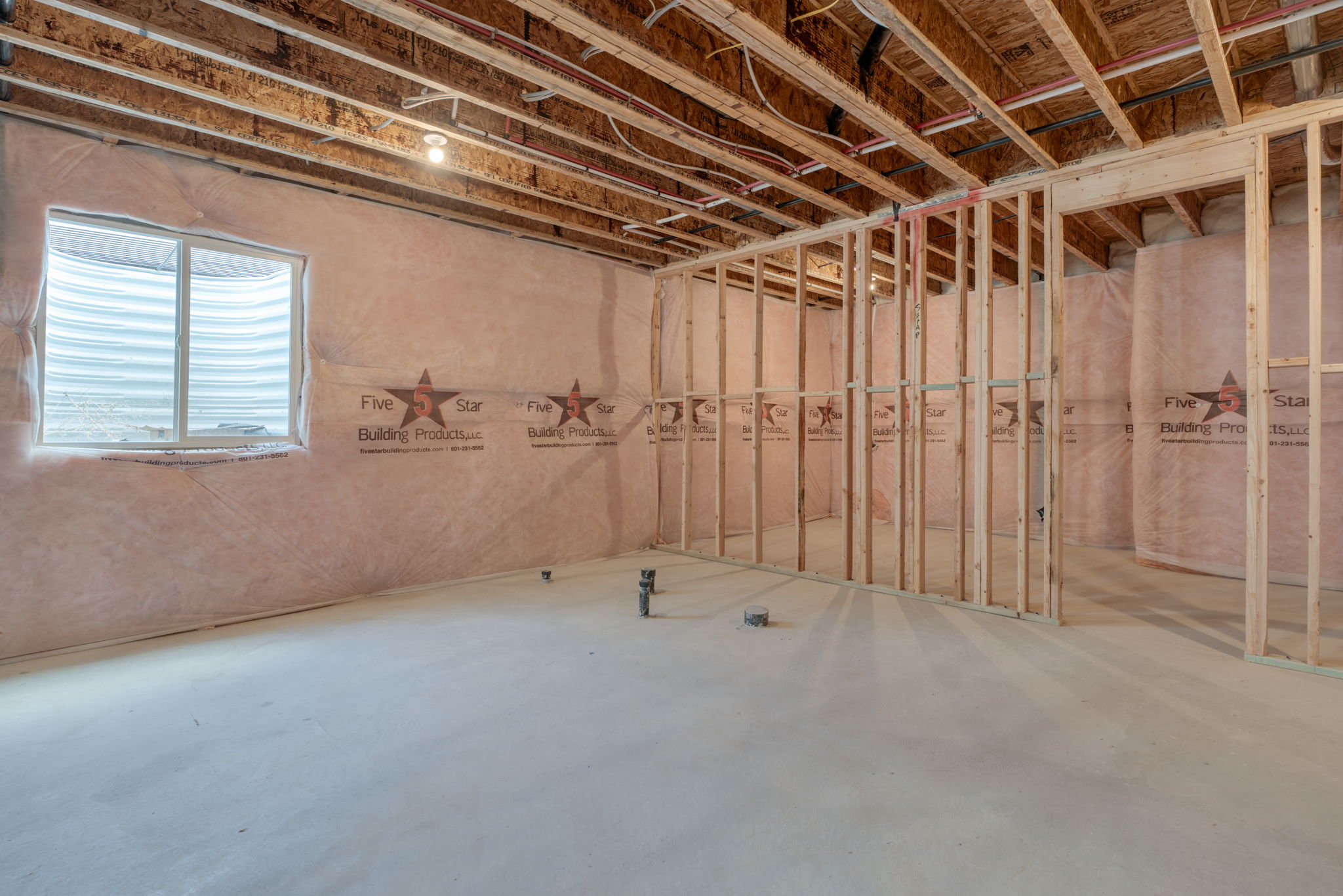 A room with a wood ceiling and a window.
