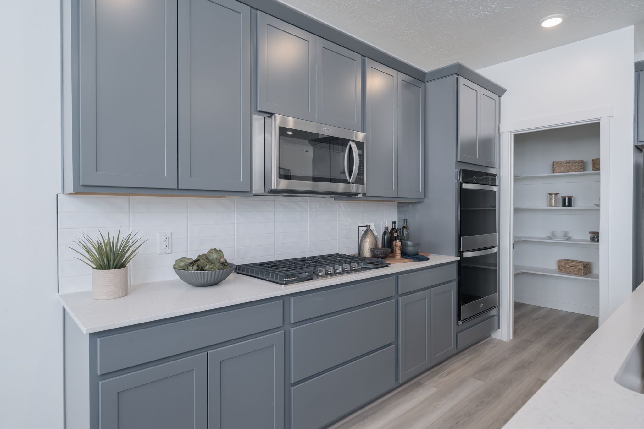 A kitchen with white cabinets.