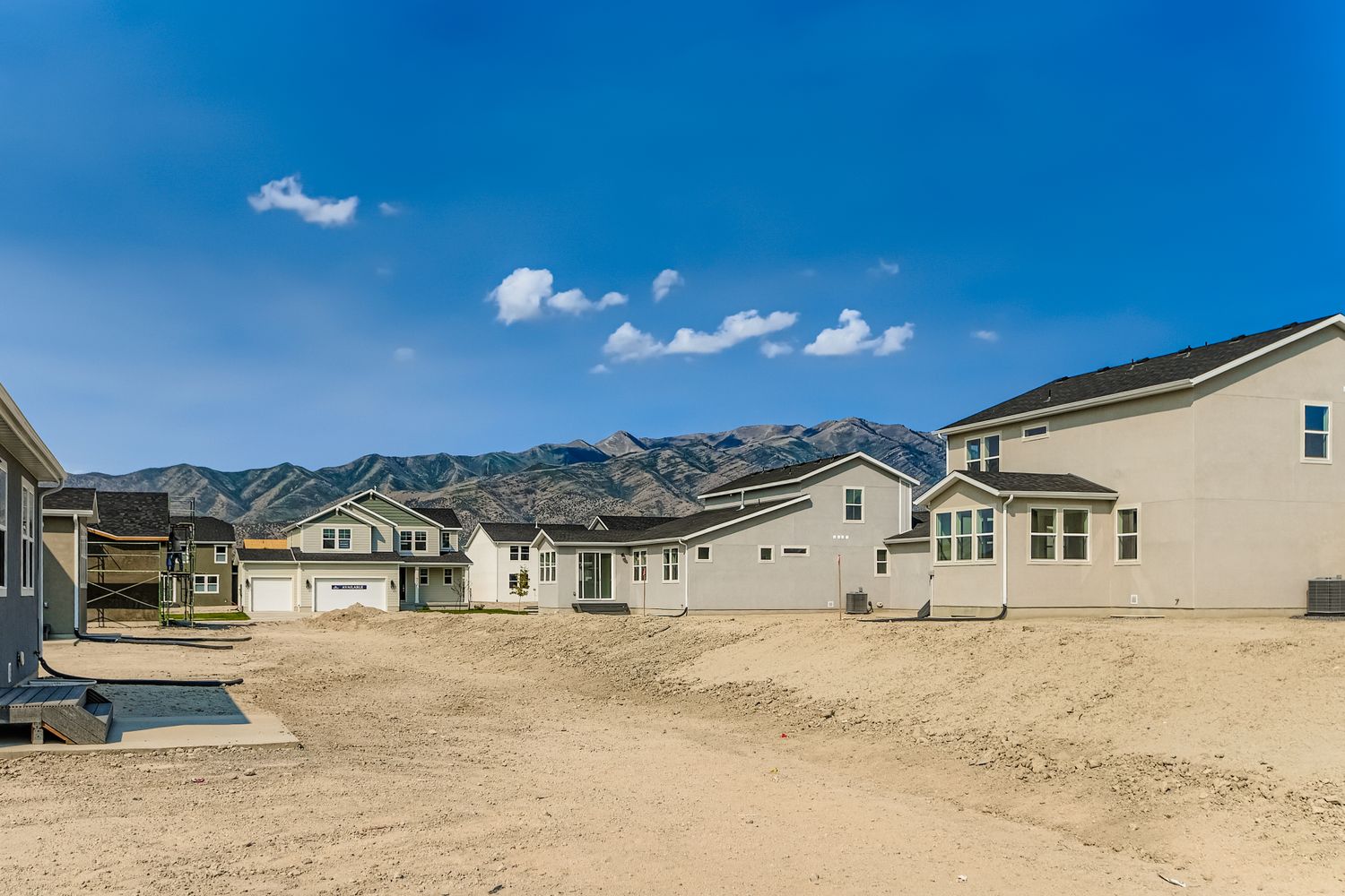 A group of houses in a sandy area.