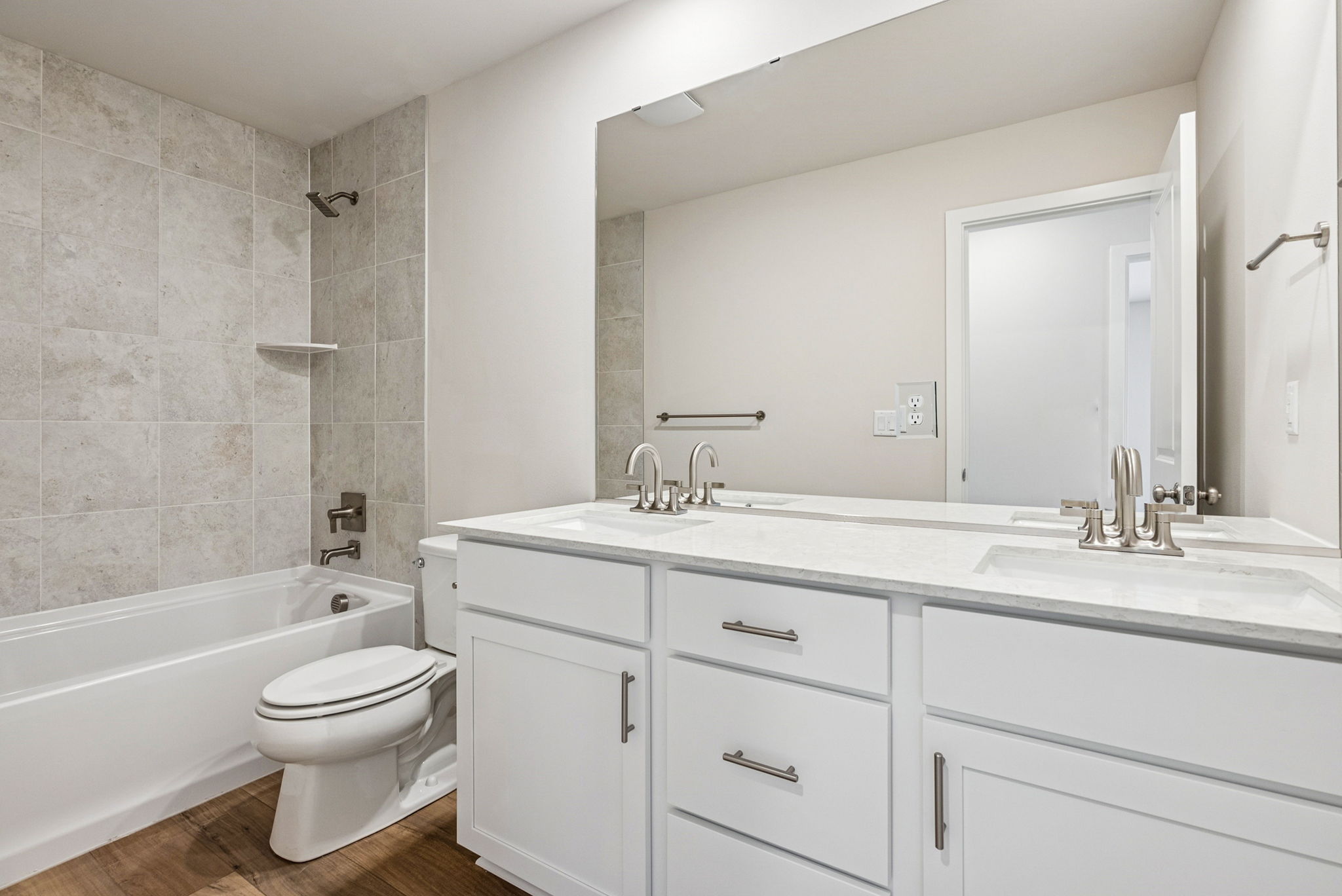 A bathroom with a tub sink and toilet.