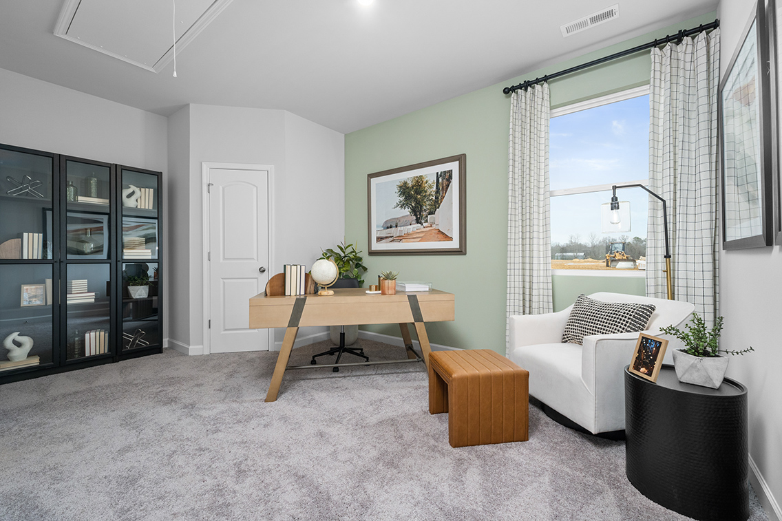 A living room with a table and chairs.