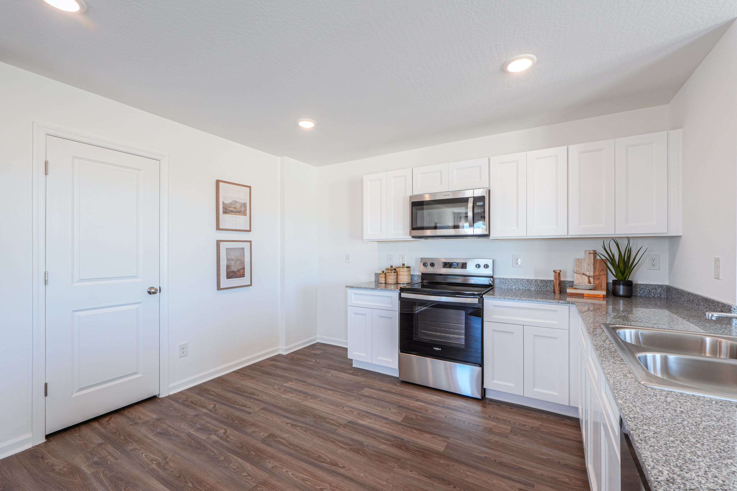 A kitchen with white cabinets.