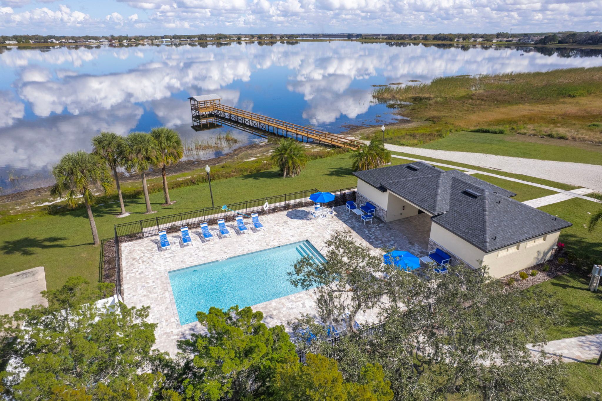 A swimming pool with a bridge in the background.