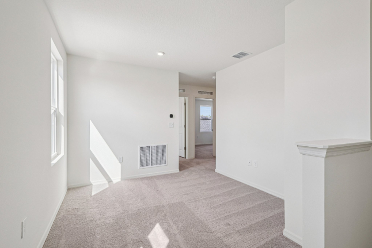 A hallway with white walls.