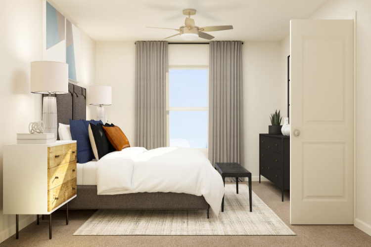 A bedroom with a bed and a fan.